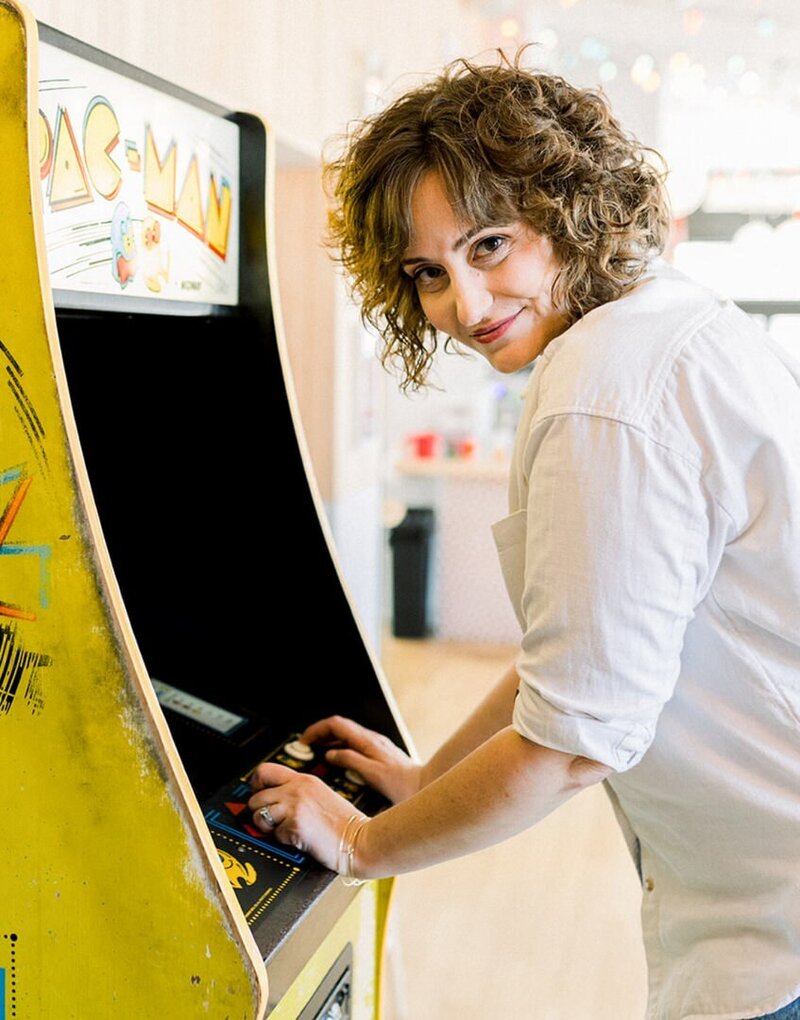 Paige Worthy playing Pac Man arcade game