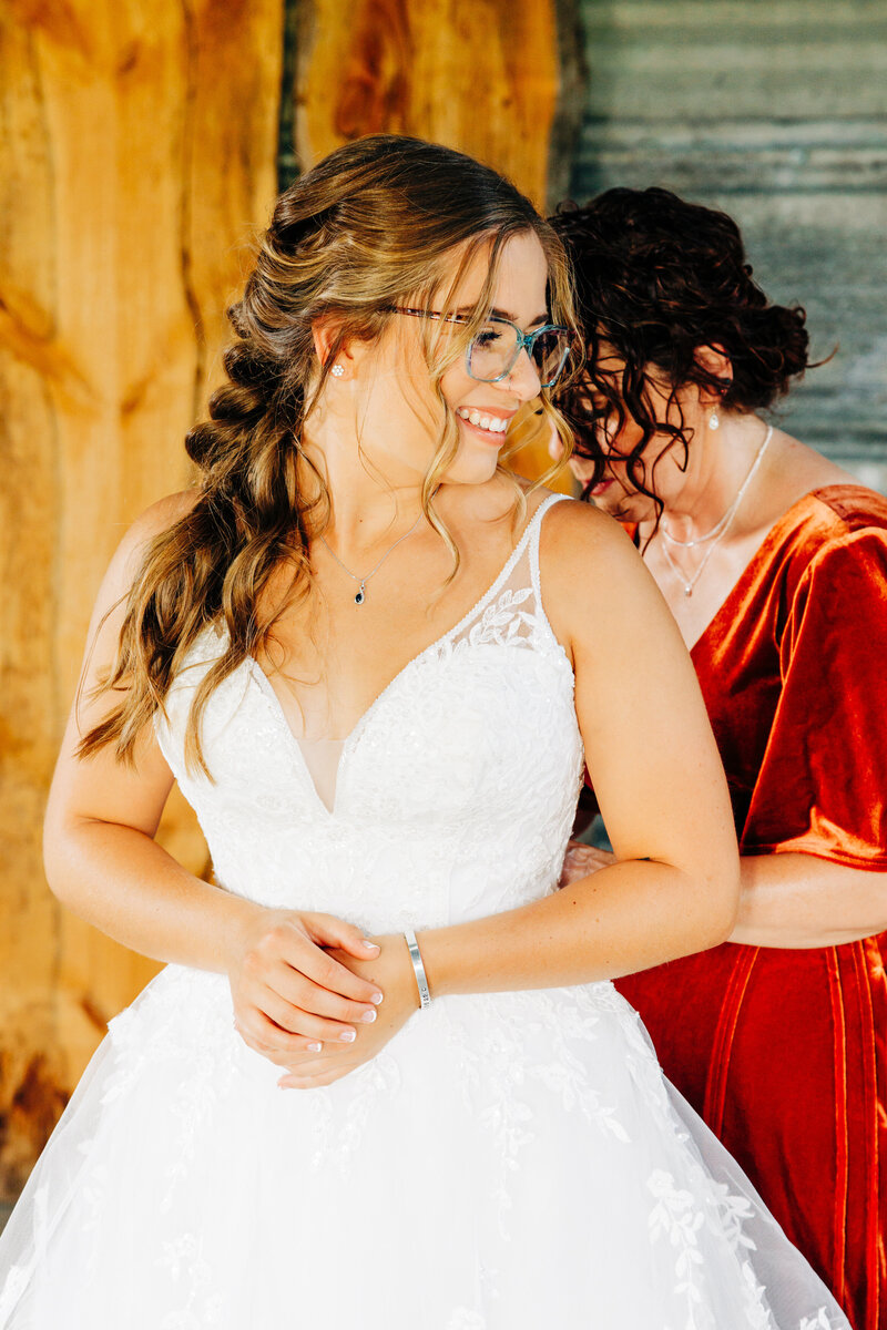 Bride getting dressed in silo at Cattle Springs in Arlee, MT