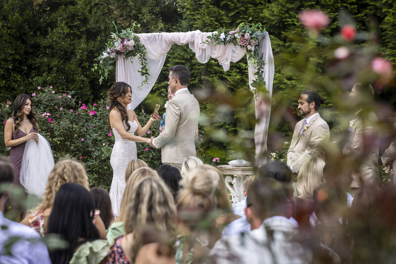 Bride and Groom kissing in between columns