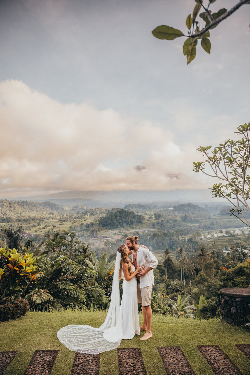 bride and groom kiss at tropical location
