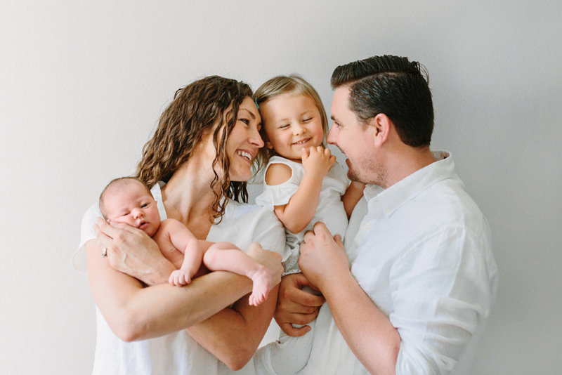 A family snuggles during their in studio portrait session in Thousand Oaks, Ca