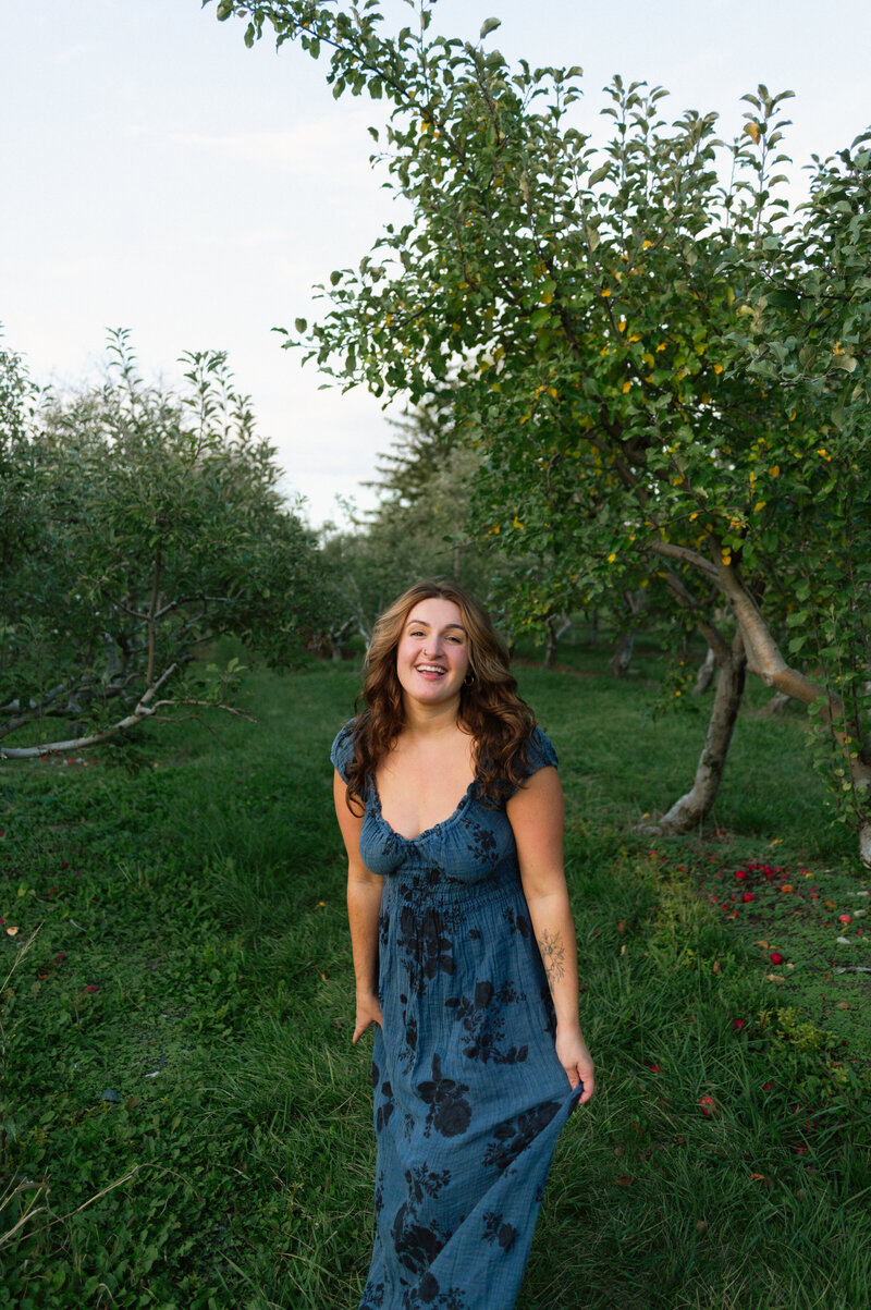 Portrait of Meg in front of pine trees