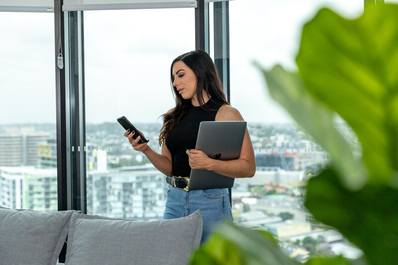 A phone sitting on a planner by keyboard