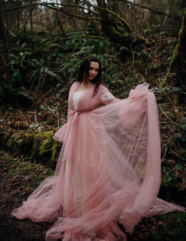 a mand and woman in wedding attire stand on the rocky beach shores of Yachats in Oregon