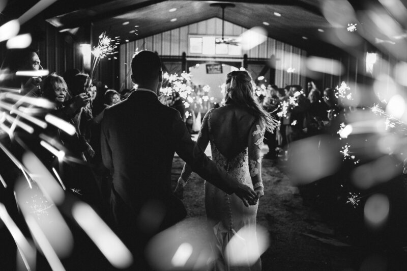 beautiful sparkler exit at addison grove located in texas. couple hold hands as they set off to their honeymoon