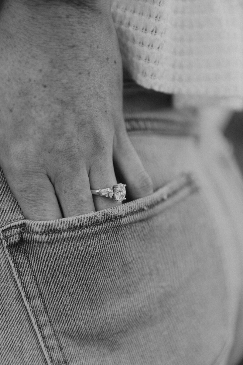 Detail shot of an engagement ring tucked into the pocket of denim jeans—captured by a Midwest wedding photographer specializing in candid, artistic photos for couples in Ohio and Michigan.