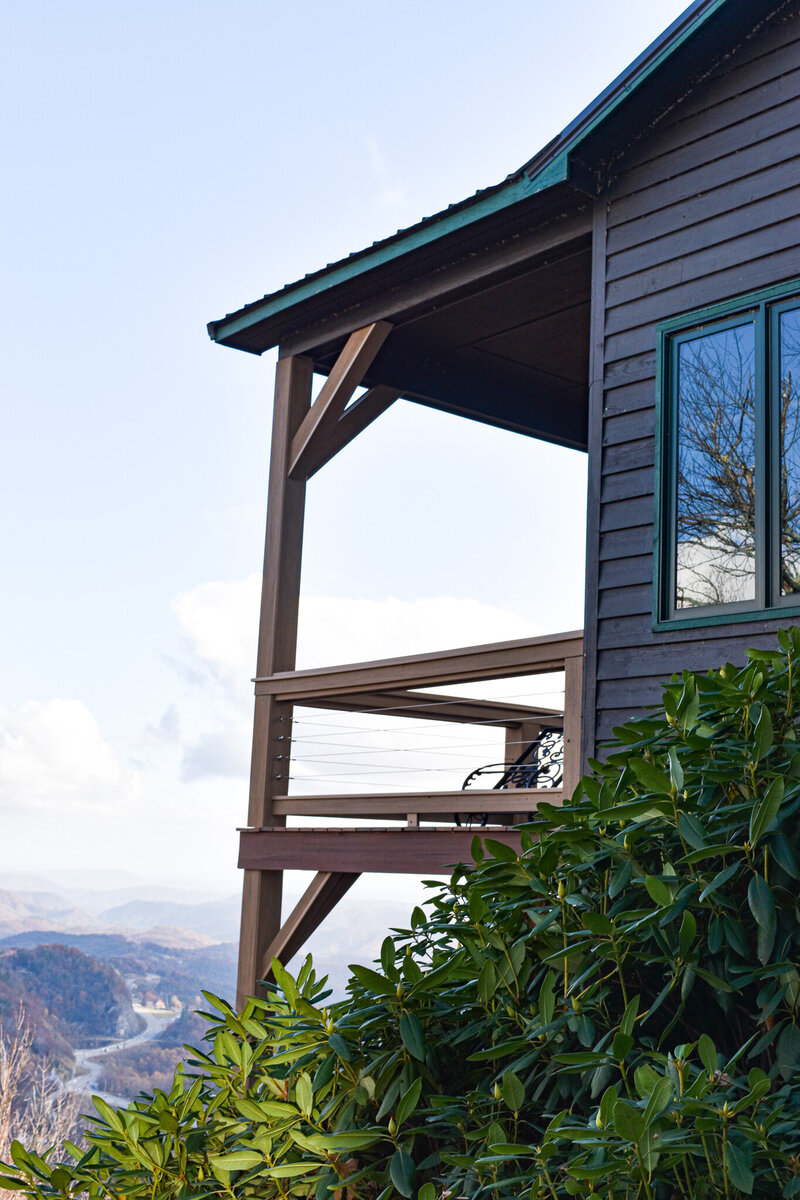 Mountain House exterior back porch. Home Siding and deck build Remodeling project.