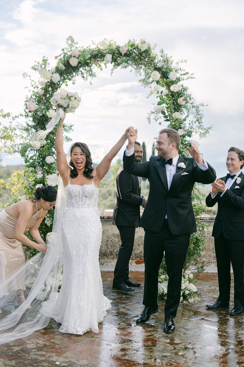 a bride and groom celebrating after their wedding ceremony