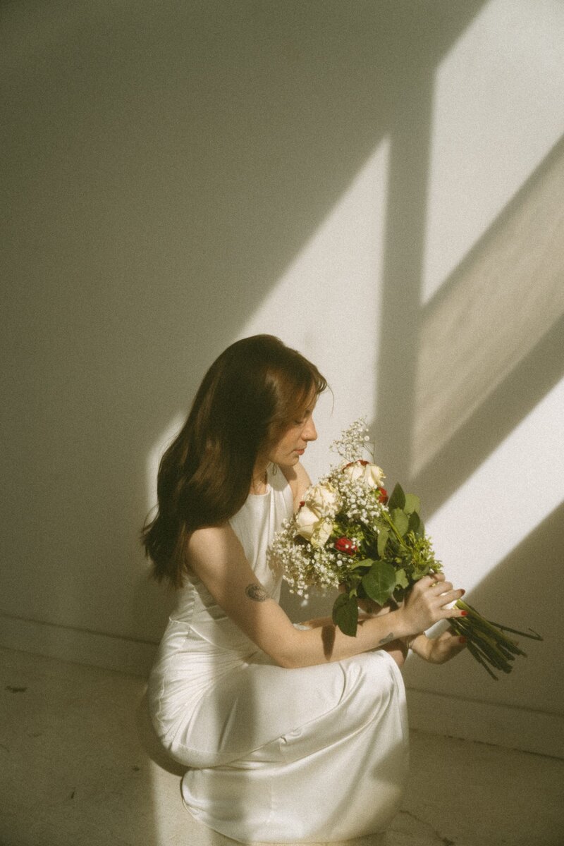 studio portrait of girl holding flowers