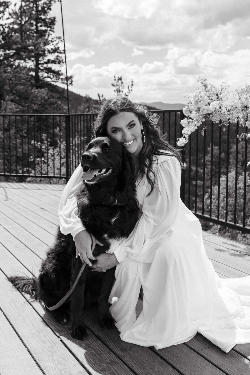 Bride shares hug with her dog at her North Star Gatherings Colorado Mountain wedding 
