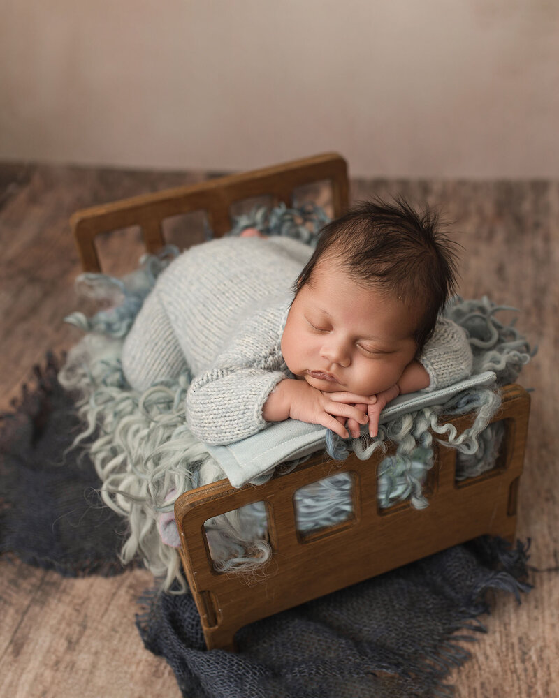 baby boy olaying in bed
