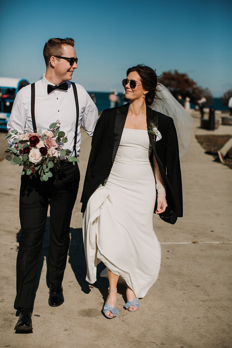 Bride and groom walking on chicago lakefront at adler planatarium