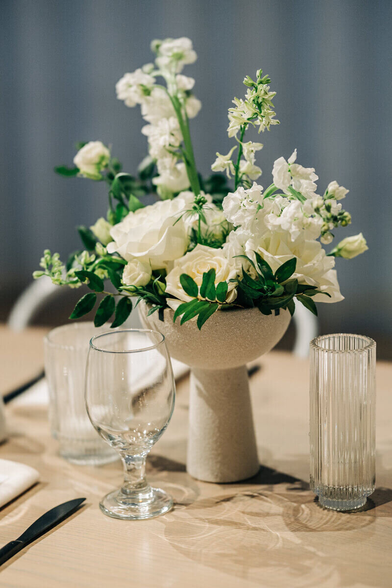 Wedding flowers in a pot on table designed by wedding florists minneapolis