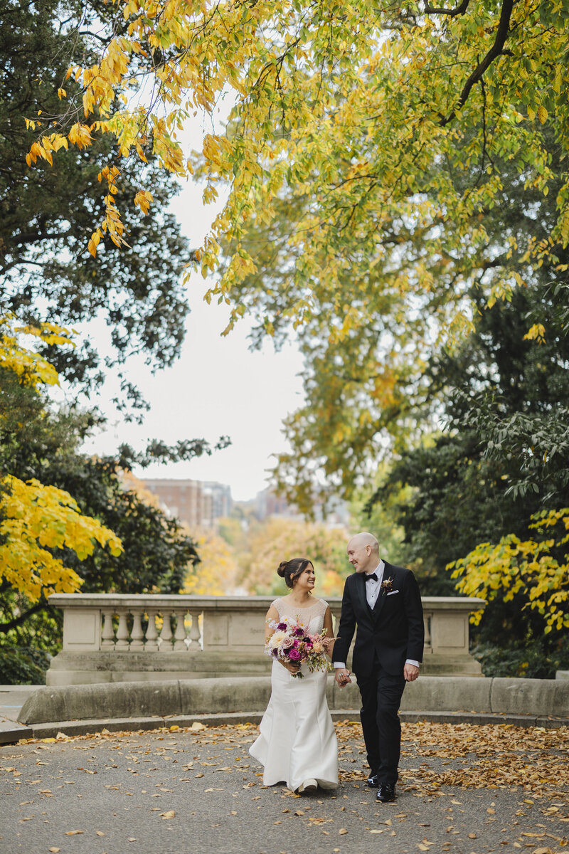 A couple walks hand in hand at a Hotel Washington wedding.