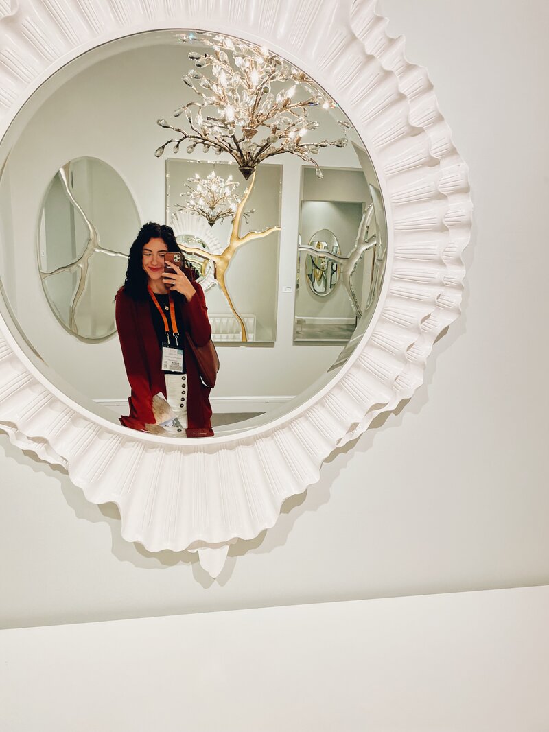 Girl poses in front of mirror at Interior Design showroom