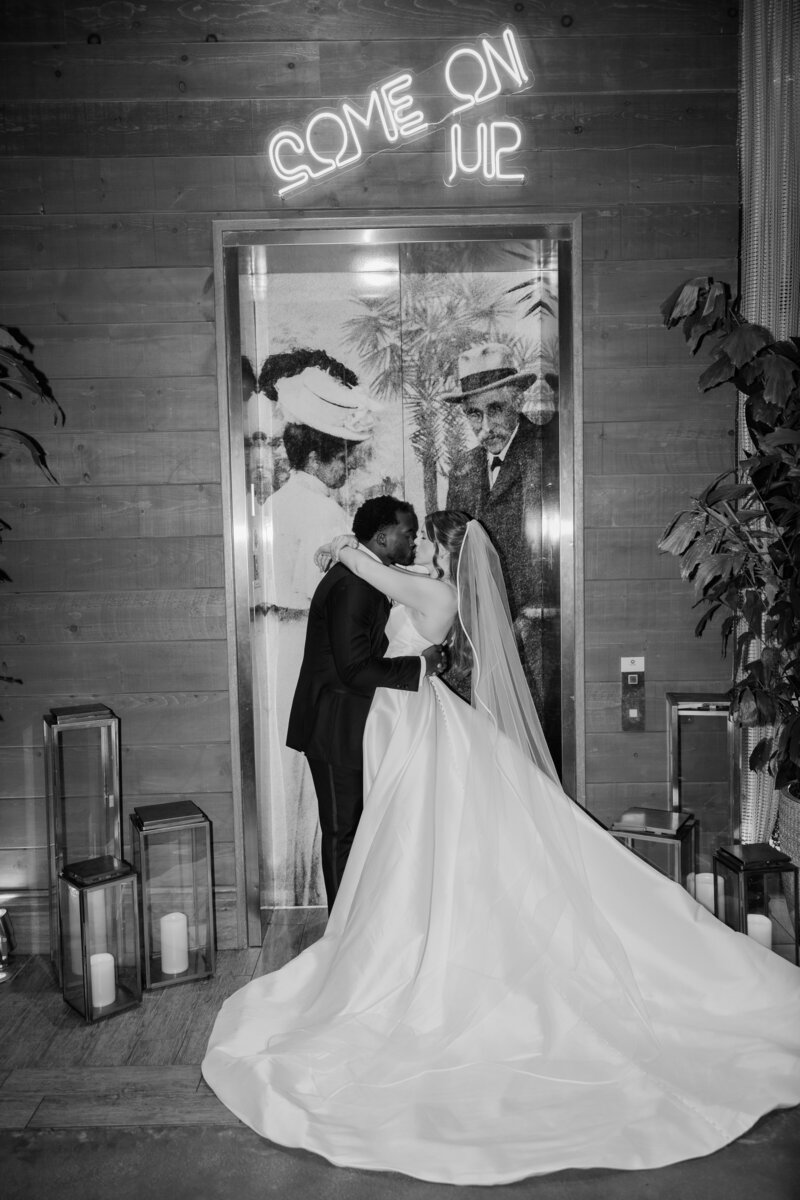 Bride and Groom in front of an elevator at the Ben, Autograph Collection in West Palm Beach. 