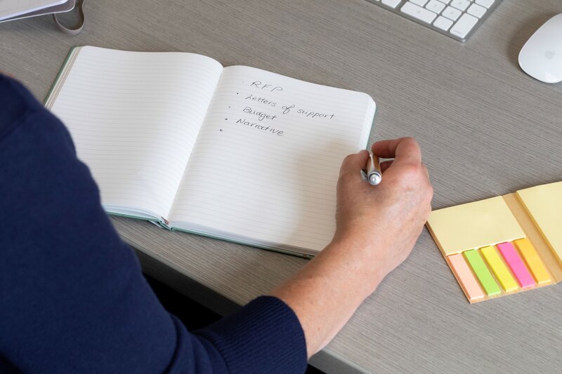 Francine's hand writing in notebook while sitting at desk