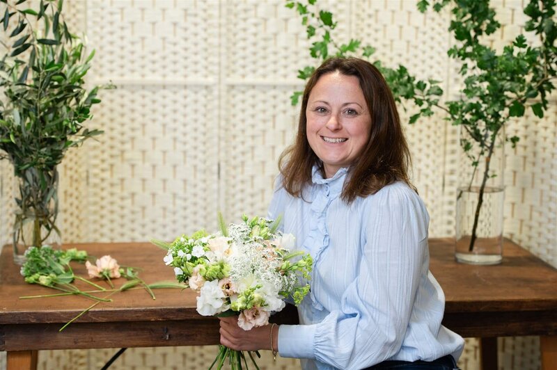 Anna Sawle | Wedding flowers in Cornwall decorating a reception table with flowers for a Carbis Bay Hotel wedding