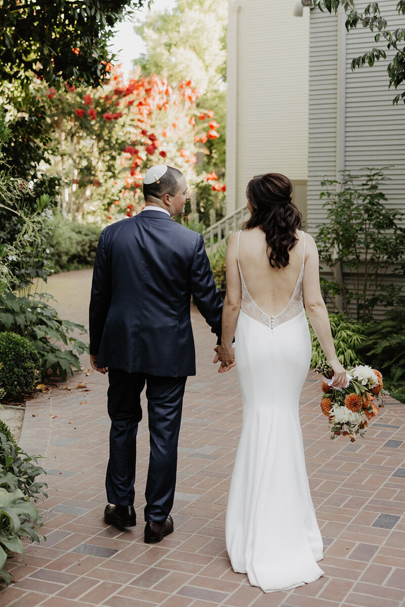 Bride and groom walking hand in hand after ceremony