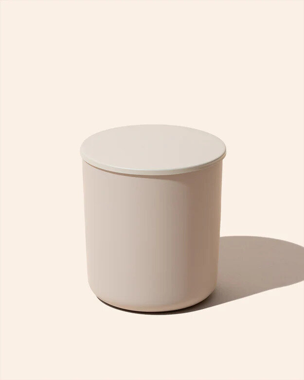 Noura Blanc Aura Candle in Cream Small with Lid on flat lay