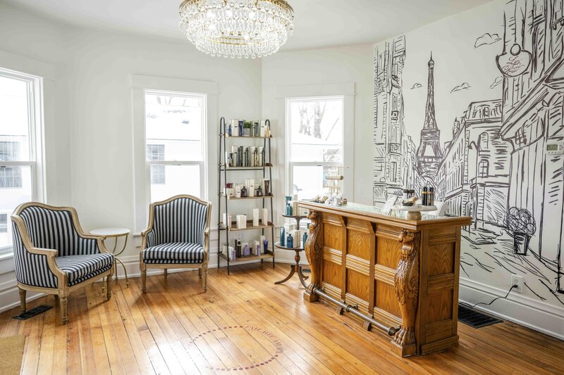 Natural light salon with hair products display and salon desk