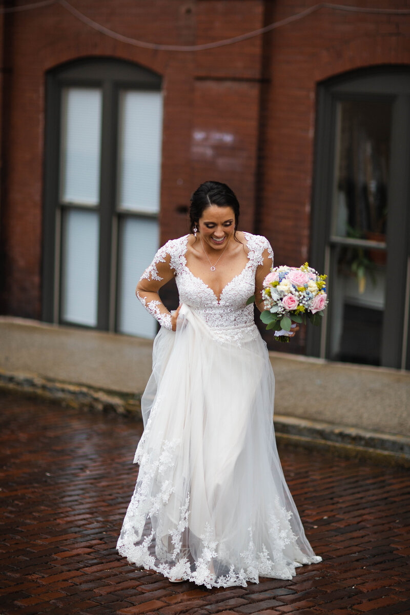 Bride in Knoxville TN walking and holding wedding dress