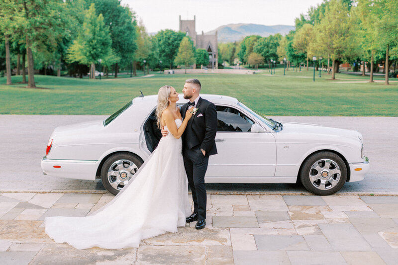 Bride and groom walk down stone castle steps