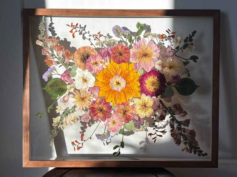Dried and framed flowers representing bridal bouquet preservations services offered by Dame Designs.
