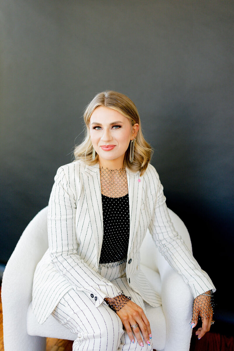 woman seated in blazer