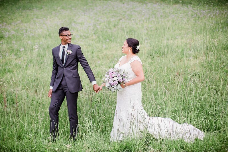 holding hands in a field by Knoxville Wedding Photographer, Amanda May Photos