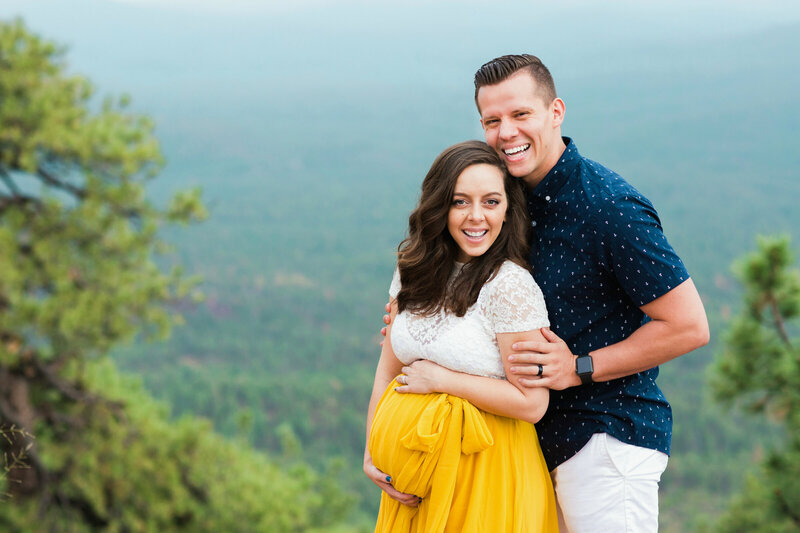 expecting parents embracing each other and baby bumo