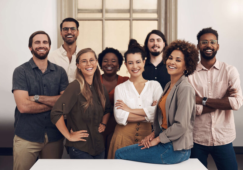 Smiling, diverse team representing organizational collaboration and growth through the Impact Flow Accelerator Program.