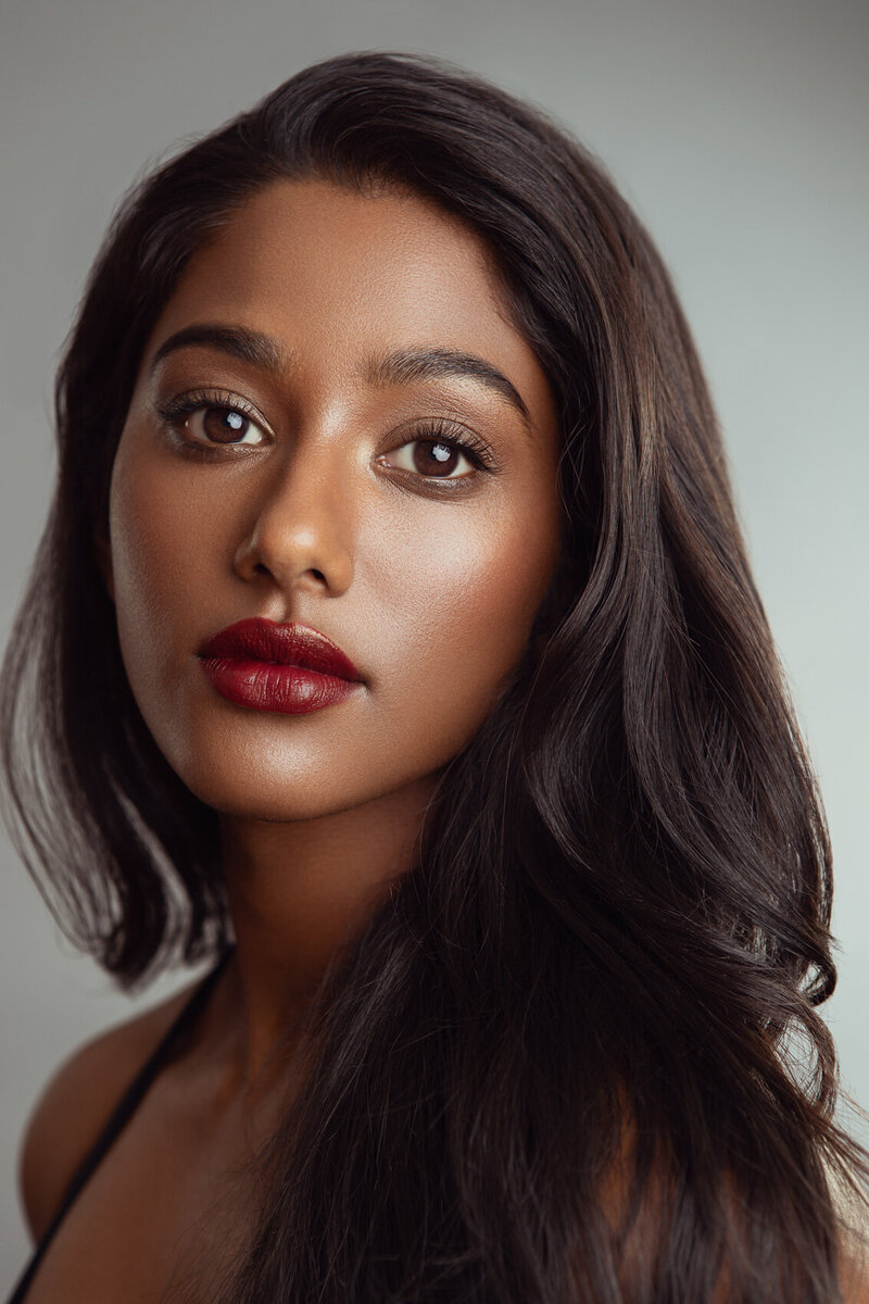 Sitara Masa in a vibrant portrait with bold styling and deep red lips, photographed by Ylva Erevall.