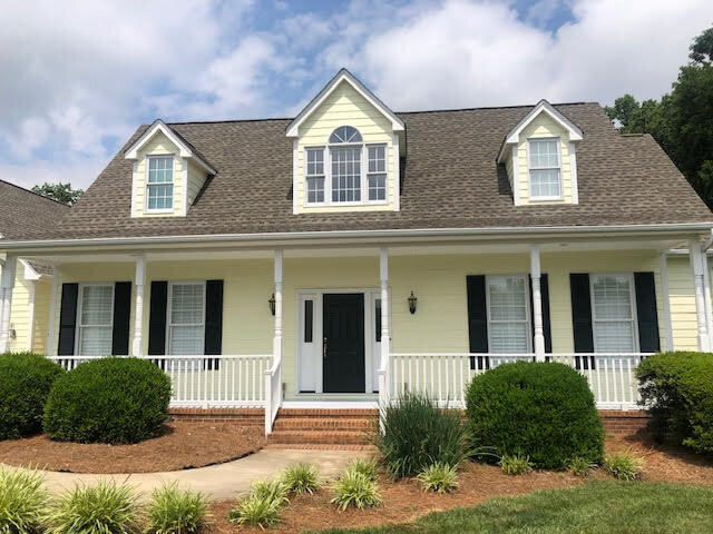 Exterior house painting project completed with new siding color