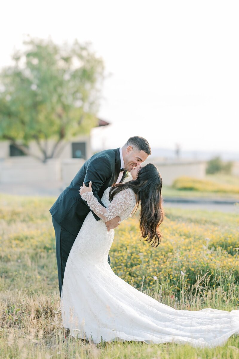 Groom kissing bride at Holman Ranch in Carmel Valley