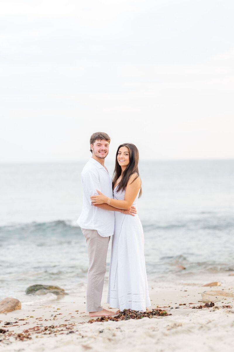 A man and his girlfriend caress one another on the beach at Harkness Memorial State Park. 