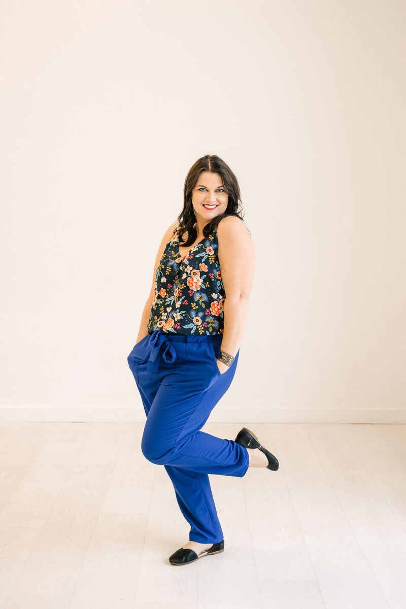 colorful new braunfels texas wedding photographer smiles at camera during branding photoshoot