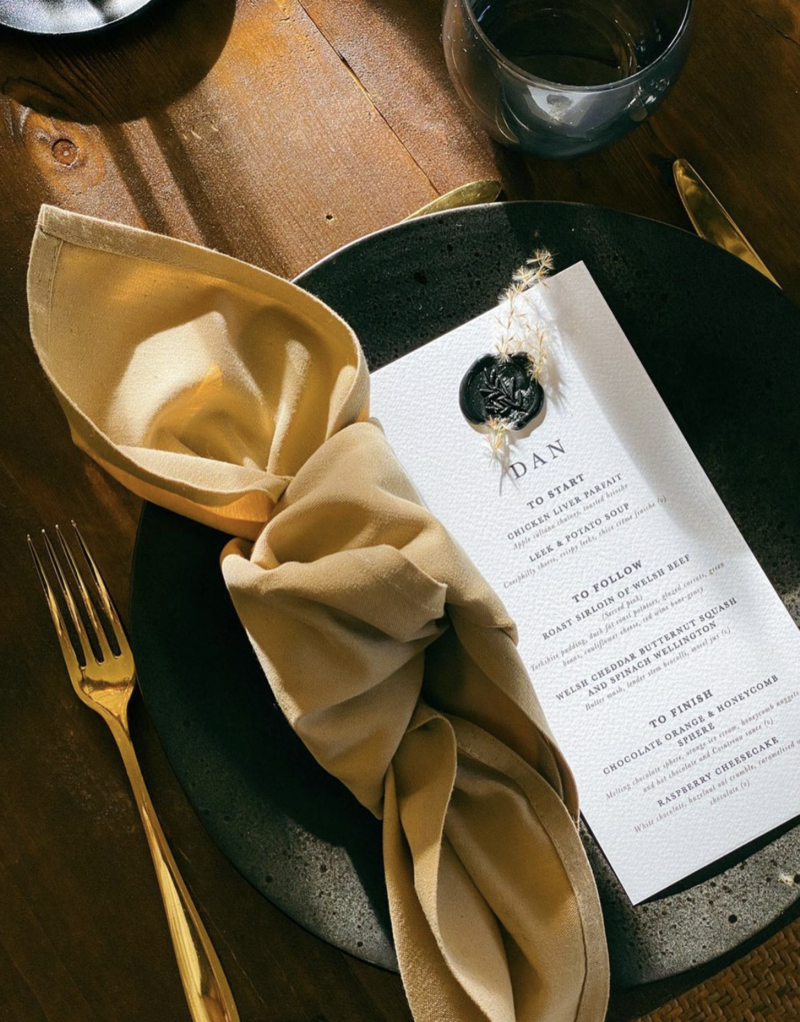 Wedding menu place names, black and gold styling with wax seal stamped on dried flower