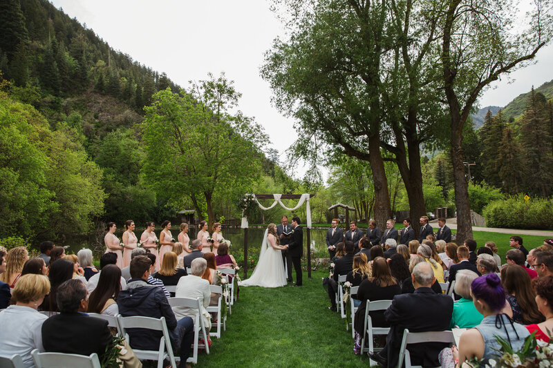 bride and groom kissing during outdoor wedding ceremony
