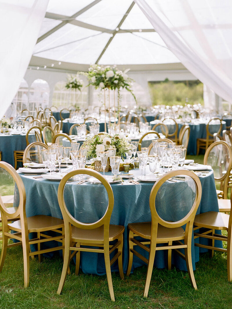 Custom and bespoke wedding table setting under an events tent
