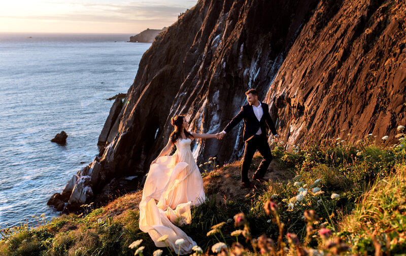 A romantic elopement shoot featuring a couple wrapped in love, with breathtaking Pacific Northwest coastal views at sunset.