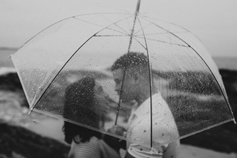 C & N standing under an umbrella