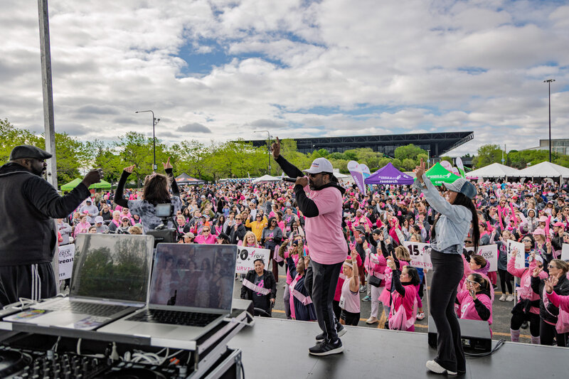 DJ Marz of charizma entertainment performing in front of the crowd wearing pink shirt