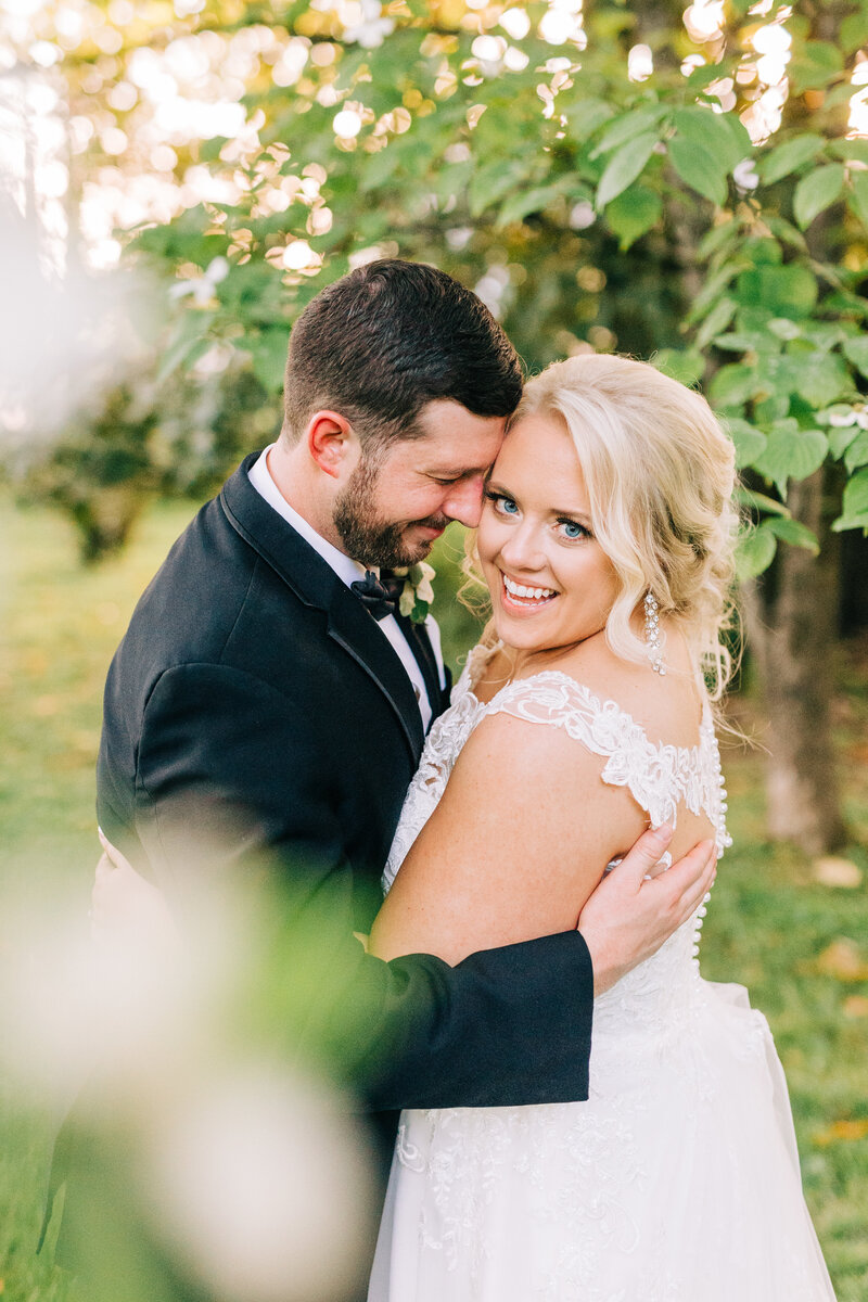 bride smiling while groom nuzzles brides forehead smiling, winx photo tennessee wedding photographer