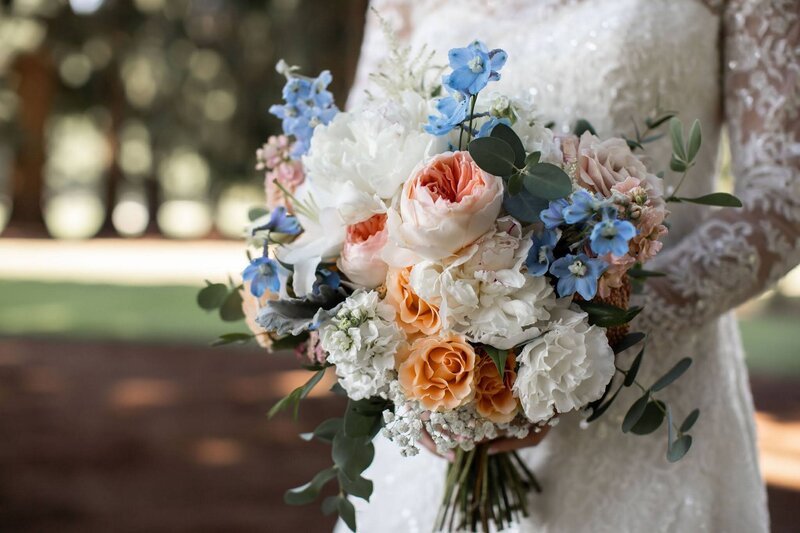 Bridal bouquet by Flowers and Thyme feturing shades of blue, pink, cream and peach.
