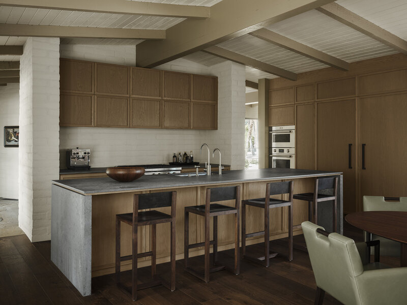 Modern residential kitchen design in Rancho Mirage with open slider designed by Los Angeles architect Sean Lockyer