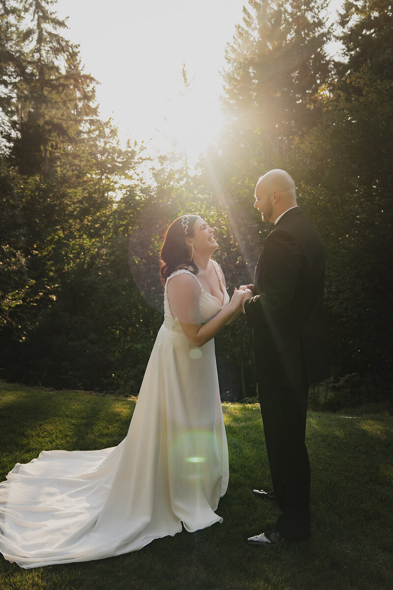 happy newlyweds under shining sun outside candit shot