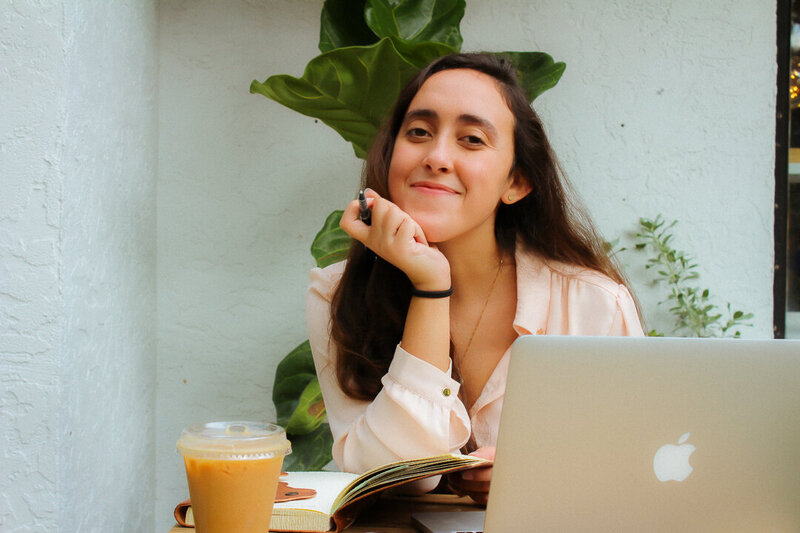 girl smiling in front of a computer