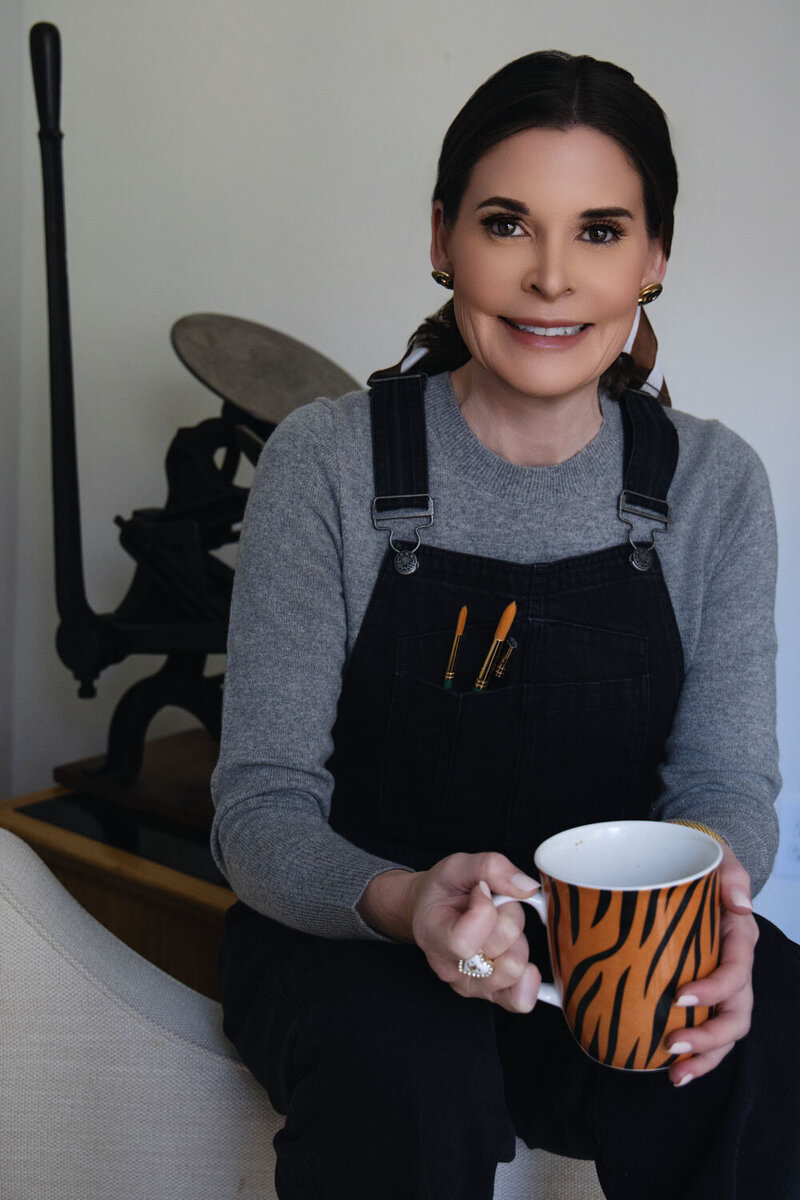 Erin Eileen, a Washington DC calligrapher standing by a letterpress tray