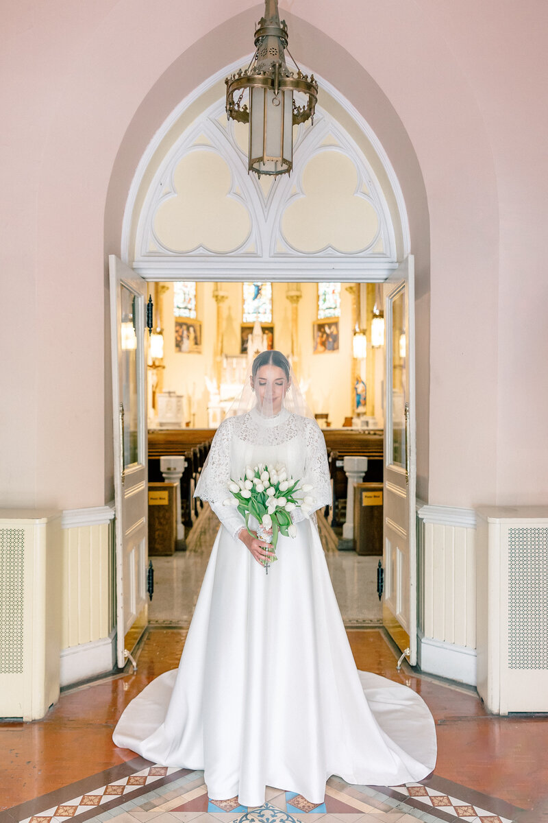 Atlanta Wedding Photographers | Bride In Long Sleeve Wedding Gown And White Bouquet For Traditional Catholic Wedding